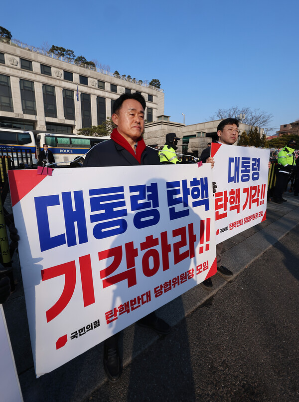 국민의힘 심재돈 인천 동구·미추홀구갑 당협위원장(왼쪽), 이상규 성북을 당협위원장이 6일 서울 종로구 헌법재판소 앞에서 대통령 탄핵 기각 촉구 릴레이 시위를 벌이고 있다(연합뉴스)