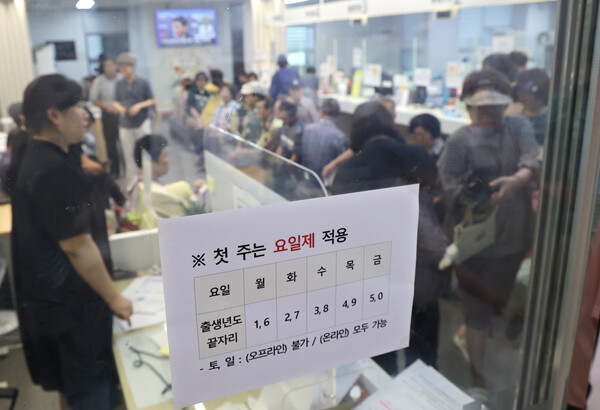 21일 부산 부산진구 가야2동 행정복지센터에서 어르신들이 번호표를 받고 대기하며 순서를 기다리고 있다 [사진=연합뉴스]